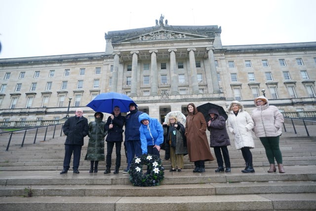 Dympna Kerr (centre), sister of Columba McVeigh, lays a wreath