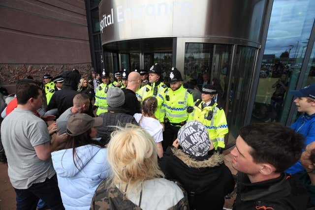 Police try to block protesters from the entrance to Alder Hey Children's Hospital in Liverpool (Peter Byrne/PA)