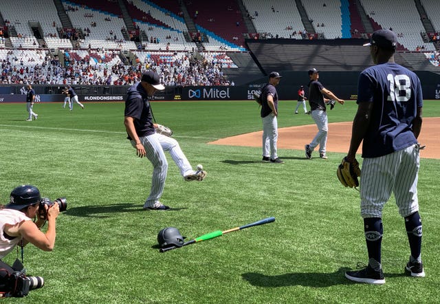 The New York Yankees' Gio Urshela, left, and Didi Gregorius play football as they warm up to face the Boston Red Sox