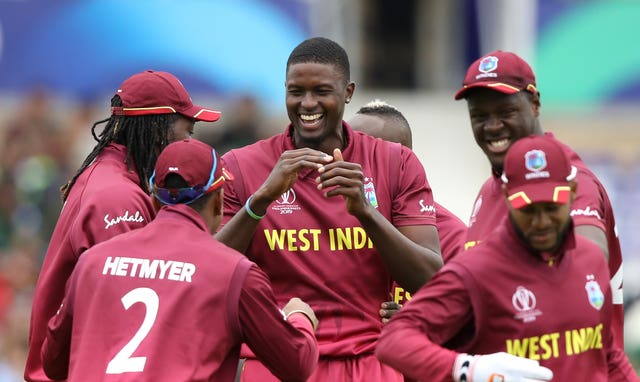Jason Holder (centre) will consult team-mates over any action.