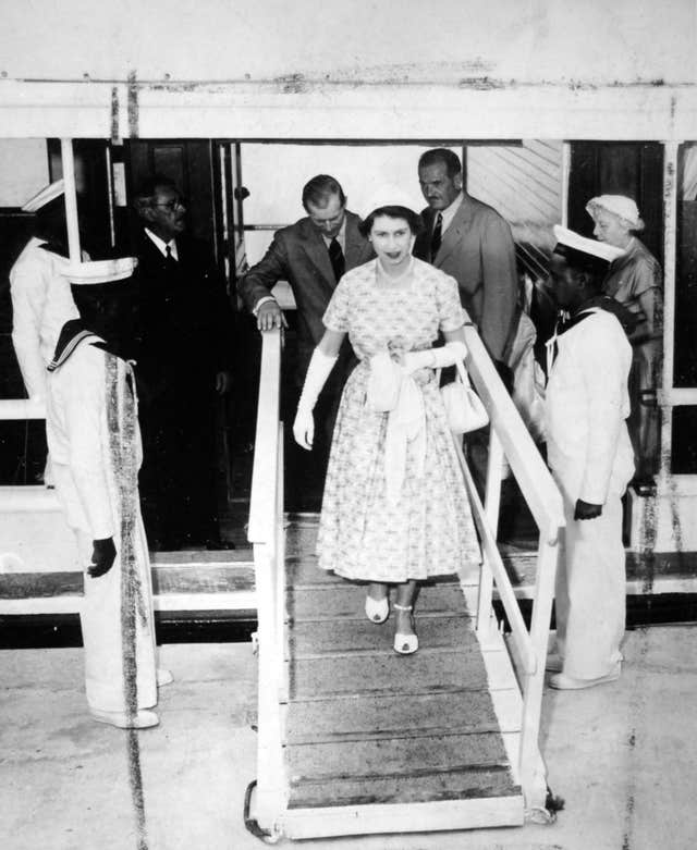 The Queen, followed by the Duke of Edinburgh, leaves the yacht Wilhelmina at Mangrove Bay, Somerset, after the cruise through the islands during her visit to Bermuda (Archive/PA)