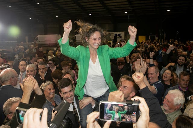 Lynn Boylan is carried aloft by a crowd with her hands in the air