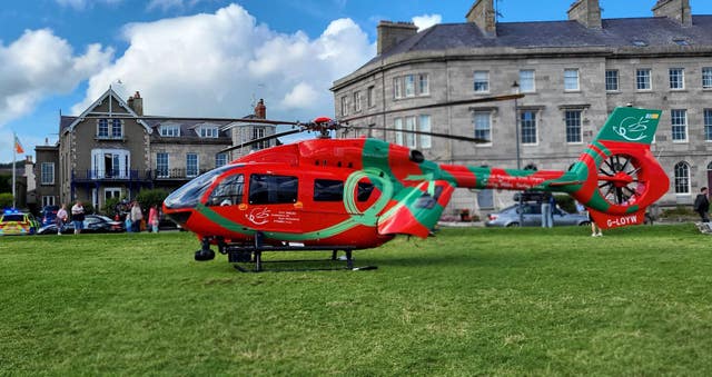 A red helicopter on a green lawn