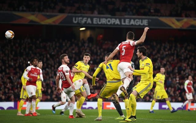 Arsenal’s Sokratis Papastathopoulos (centre) scores