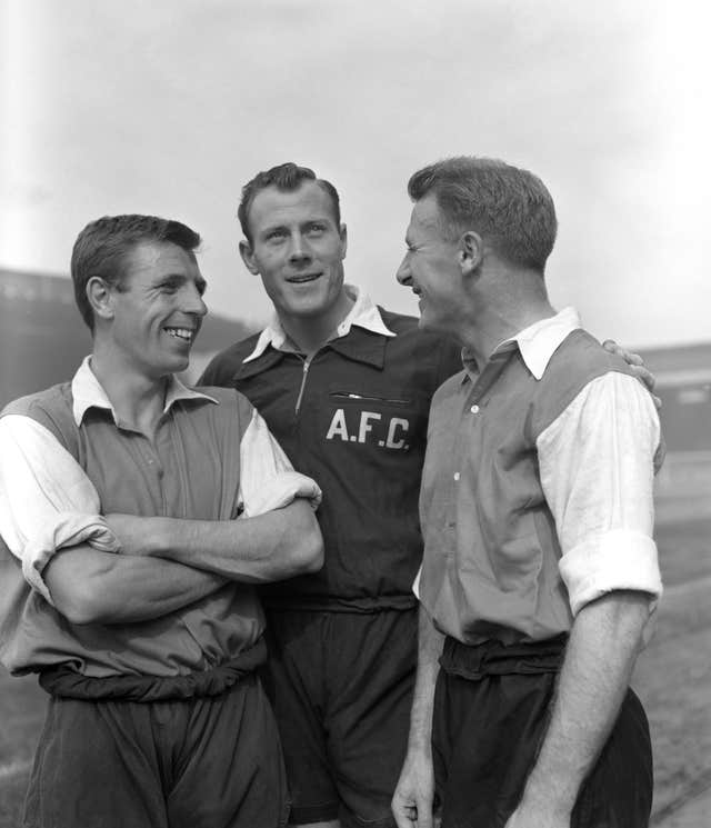 Tommy Docherty (right) after signing for Arsenal from Preston