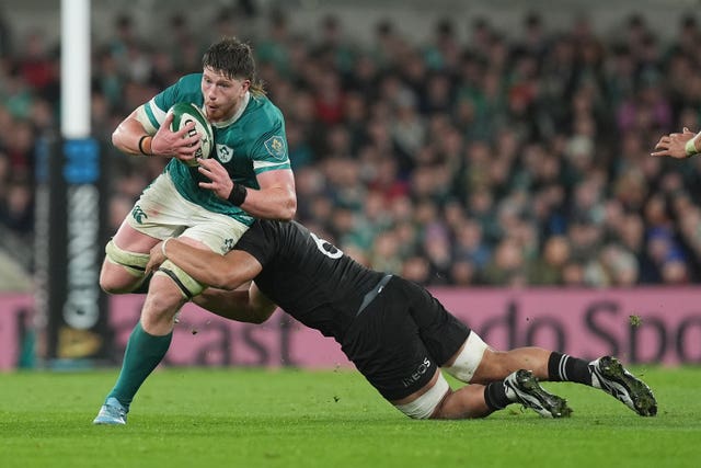Ireland’s Joe McCarthy (left) is tackled by New Zealand’s Wallace Sititi