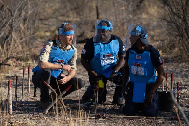 Harry chats with the Halo Trust’s Jose Antonio, centre, and a mine clearance worker