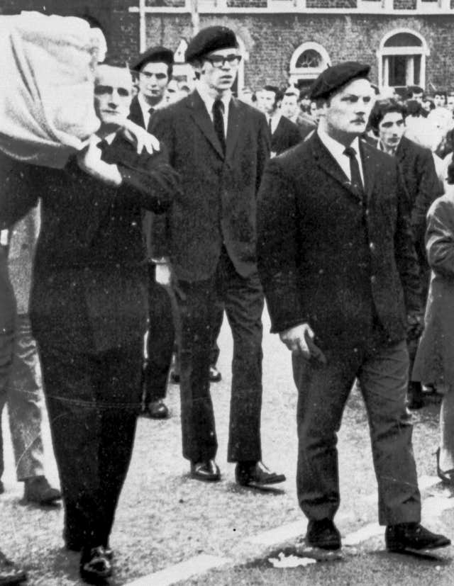 Gerry Adams (centre) in Belfast acting as a member of the IRA guard of honour (PA)