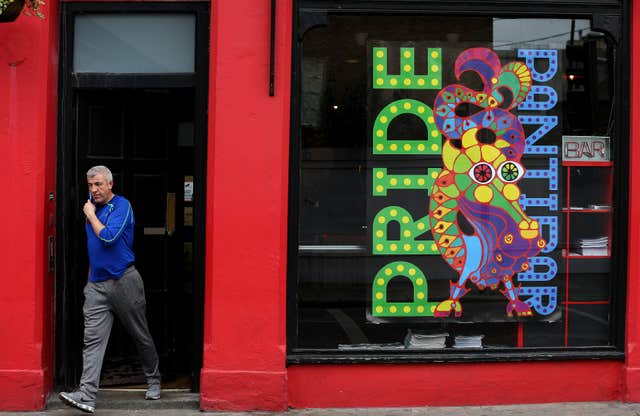 A man walks past pride posters in the window of Panti Bar on Dublin’s Capel street 