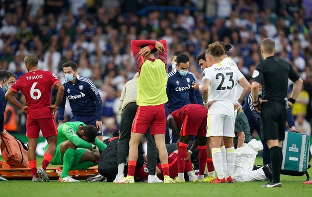 Alisson Becker, centre left, is among the Liverpool players distraught after Harvey Elliott's injury
