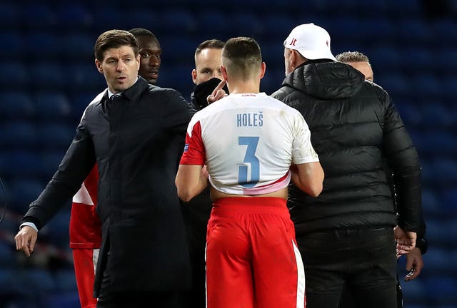 Steven Gerrard (left) speaks with Slavia Prague manager Jindrich Trpisovsky after the game