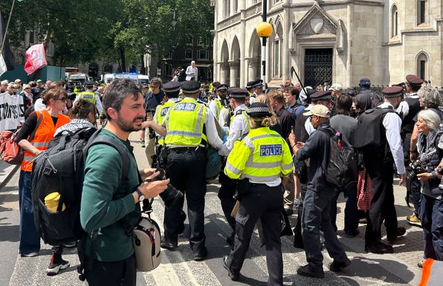 Police remove protesters outside the Royal Courts of Justice in central London