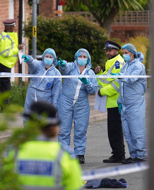 Forensic investigators in Laing Close in Hainault, north east London. 
