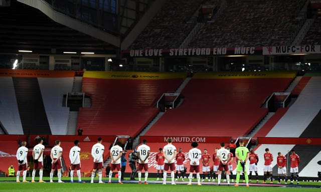 Players and officials stand for a minute’s silence for Remembrance Sunday and for Nobby Stiles 