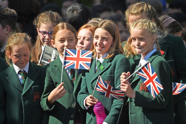 School children wait to get a glimpse of The Duchess of Cambridge as she leaves Bletchley Park