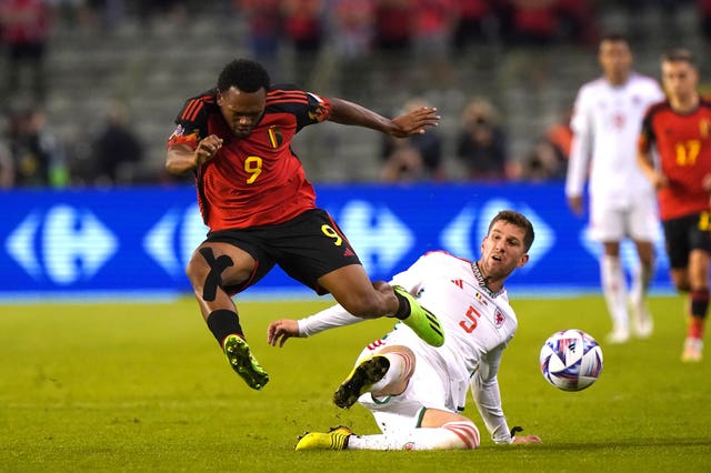 Wales’ Chris Mepham tackles Belgium’s Lois Openda, left, in Brussels