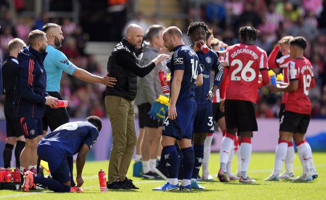 Erik ten Hag in conversation with Christian Eriksen during a coffee break at St Mary's