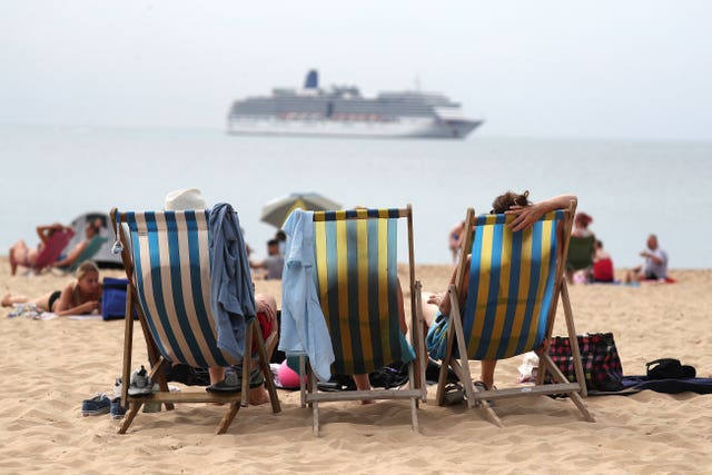 People enjoy the hot weather on Boscombe beach in Dorset, on August 8