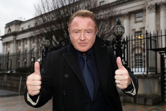 Michael Flatley giving two thumbs up outside Belfast High Court