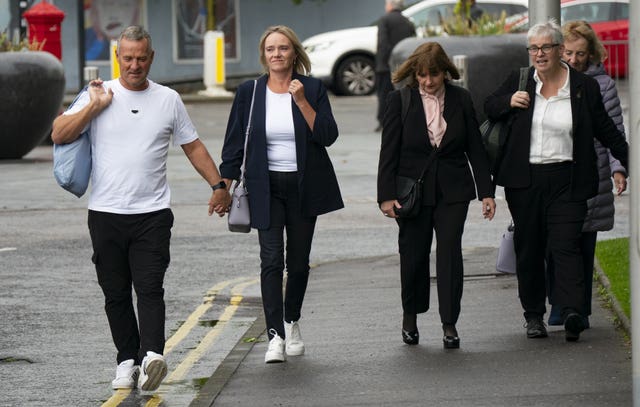 Sandie Peggie walking outside with her husband and legal team