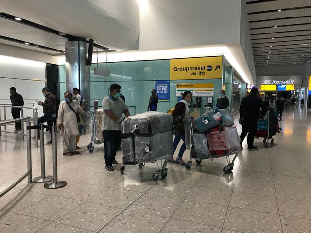 People come into the arrivals lounge in Terminal 2 at Heathrow