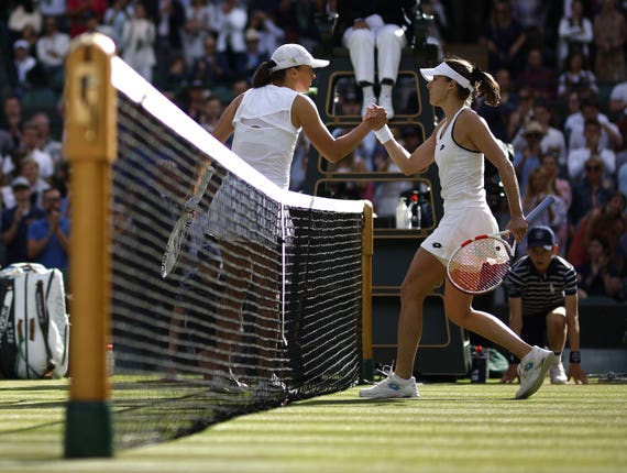Top seed Iga Swiatek was knocked out by Alize Cornet, right