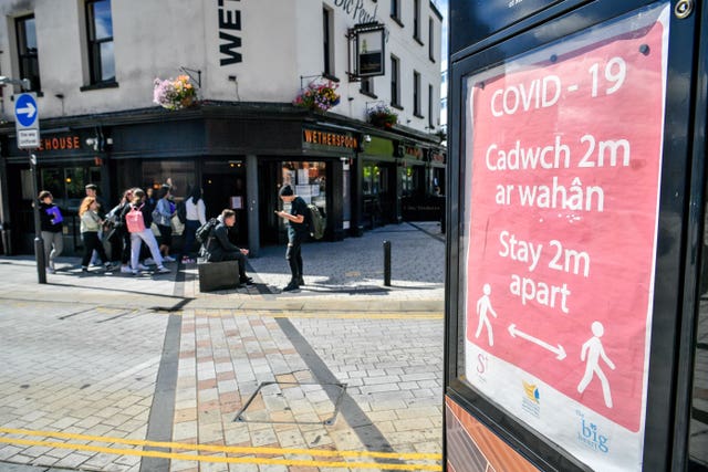 A Covid-19 poster opposite a pub in Merthyr Tydfil (Ben Birchall/PA)