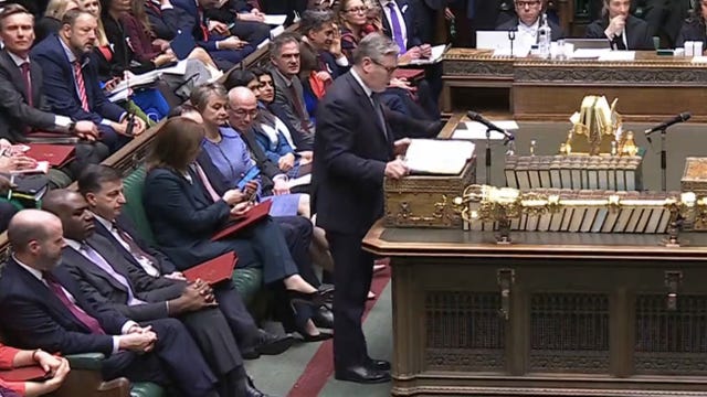 Chancellor Rachel Reeves being handed a smartphone while Prime Minister Sir Keir Starmer speaks during Prime Minister’s Questions in the House of Commons