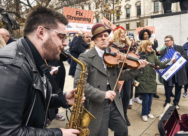 Handout photo dated 24/11/21 by Jonathan Stewart of members of the Musicians’ Union, The Ivors Academy and MPs in Parliament Square, Westminster, highlighting a new Parliamentary Bill which aims to ensure artists are “fairly paid” for streams of their music