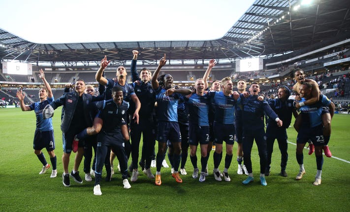 Wycombe Wanderers celebrate reaching the League One play-off final despite a 1-0 loss at MK Dons