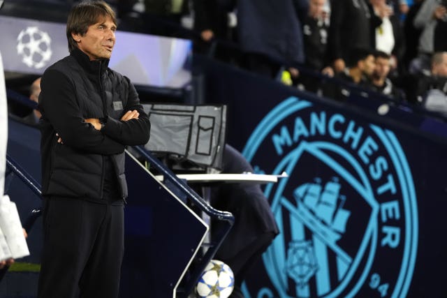 Napoli manager Antonio Conte (left) with a badge of Manchester City in the background
