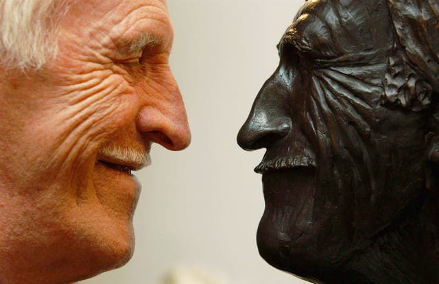 Entertainer Bruce Forsyth with the bust of himself which sits inside the Cinderella Bar at the London Palladium (Yui Mok/PA)