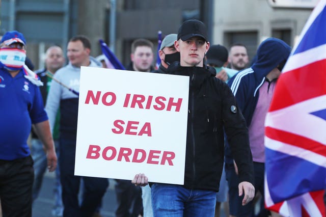 People take part in a protest against the Northern Ireland Protocol