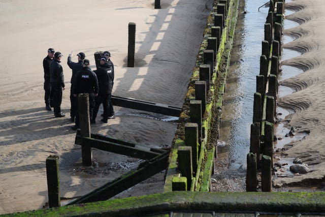 Police officers on beach