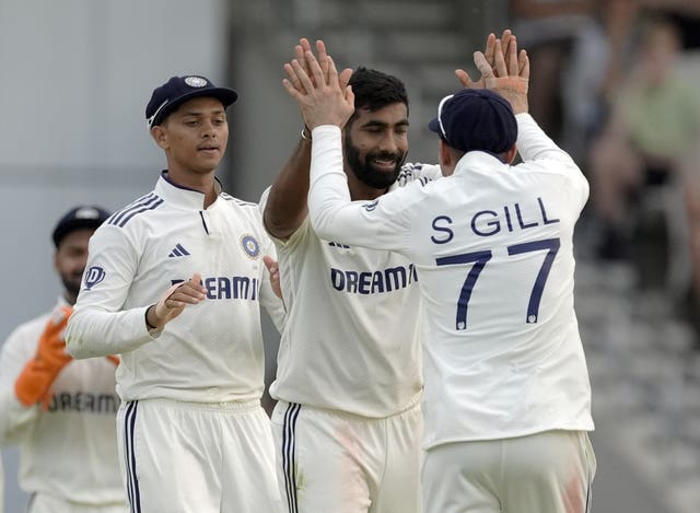 Jasprit Bumrah celebrates a wicket with teammates