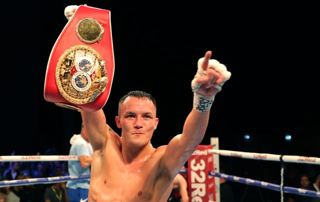 Josh Warrington celebrates with the IBF world featherweight title