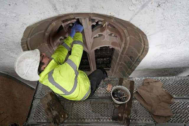A workman works on a window in restoration work at Lindisfarne Castle on Holy Island (Owen Humphreys/PA)
