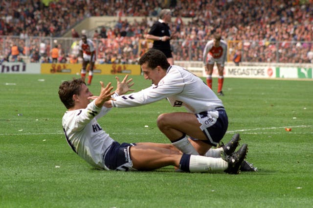 Gary Lineker, lying on the pitch with his arms in the air, celebrates with Vinny Samways after scoring a goal for Spurs