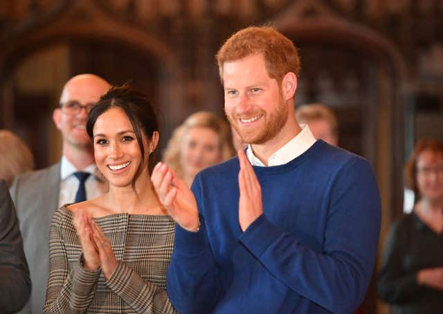 Prince Harry and Meghan Markle watch a performace (Ben Birchall/PA)