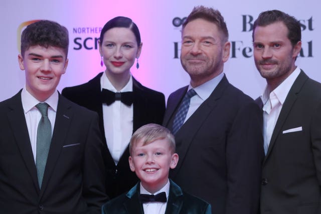 (l to r) Lewis McAskie, Caitriona Balfe, Kenneth Branagh and Jamie Dornan with Jude Hill