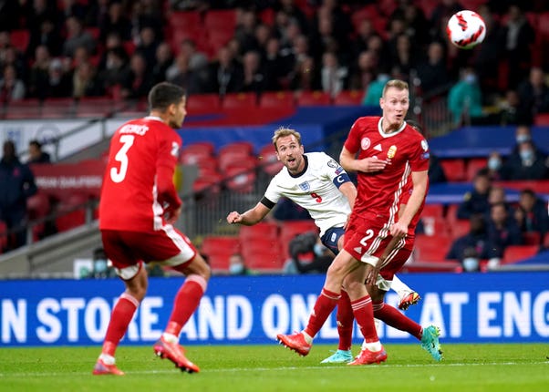 Harry Kane, centre, attempts a shot on goal against Hungary