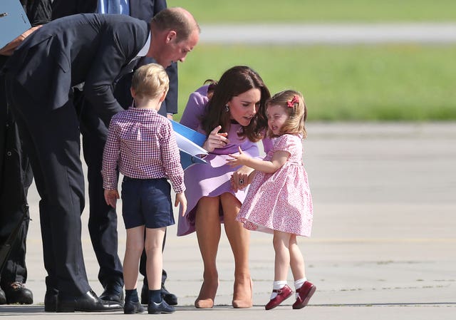 The Duchess of Cambridge talks to Princess Charlotte before the Royal party depart from Hamburg Airport (Jane Barlow/PA)