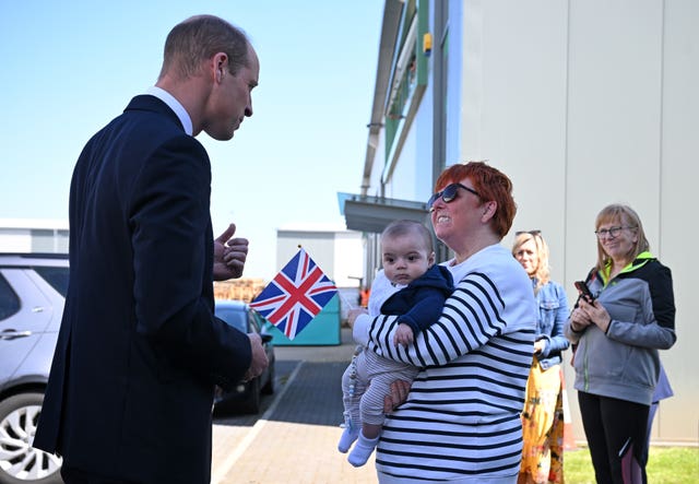 The Prince of Wales greets well-wisher Andrea Newton and her grandson as he leaves Low Carbon Materials in Seaham, County Durham 