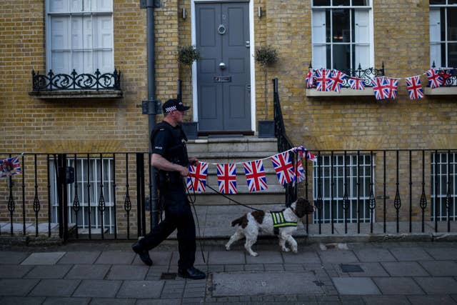 Sniffer patrol: A police officer with a sniffer dog on patrol in Windsor (Peter Summers/PA)