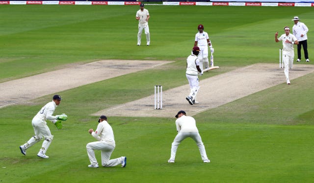 Kemar Roach is caught at slip by Joe Root, second left