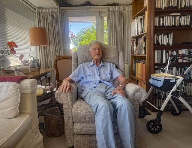 Mikael Grut sitting in an armchair in a living room
