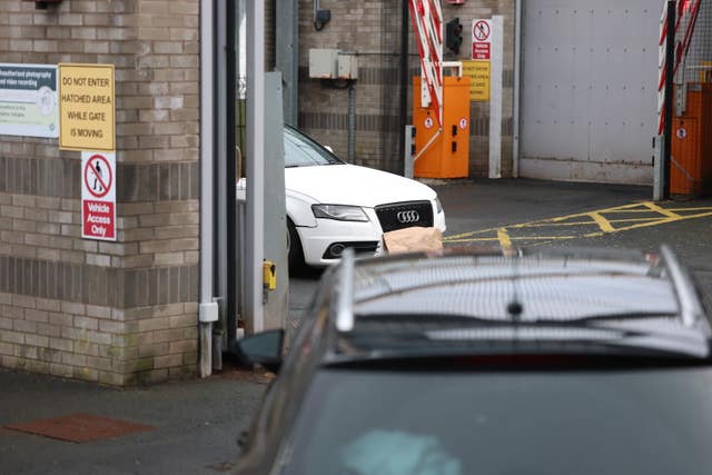 A white Audi car parked inside the police station in Lurgan, Co Armagh, after a delivery driver was threatened at gunpoint