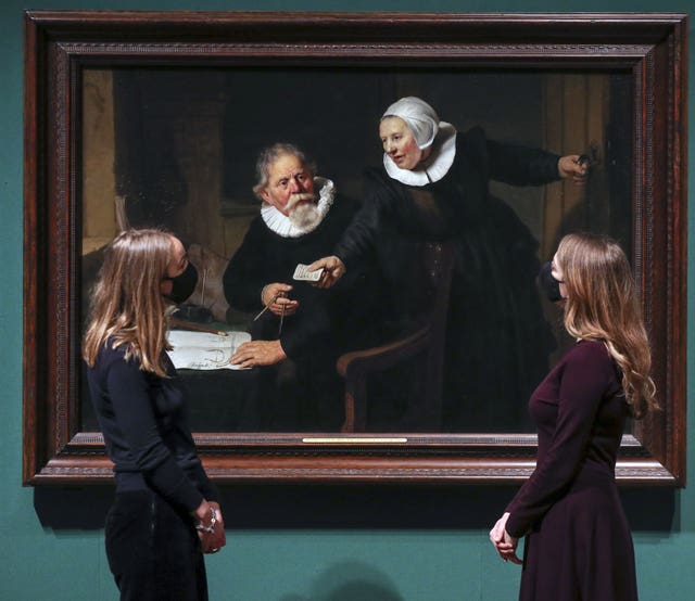 Women look at Rembrandt’s painting The Shipbuilder and his Wife
