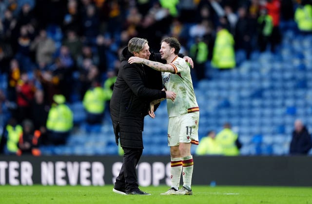 Wimmer and Andy Halliday embrace after victory at Ibrox
