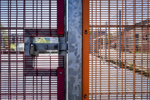 A padlock and bolt secure the mesh fencing to a five-a-side pitch in Bristol to prevent access as the UK continues in lockdown to help curb the spread of the coronavirus